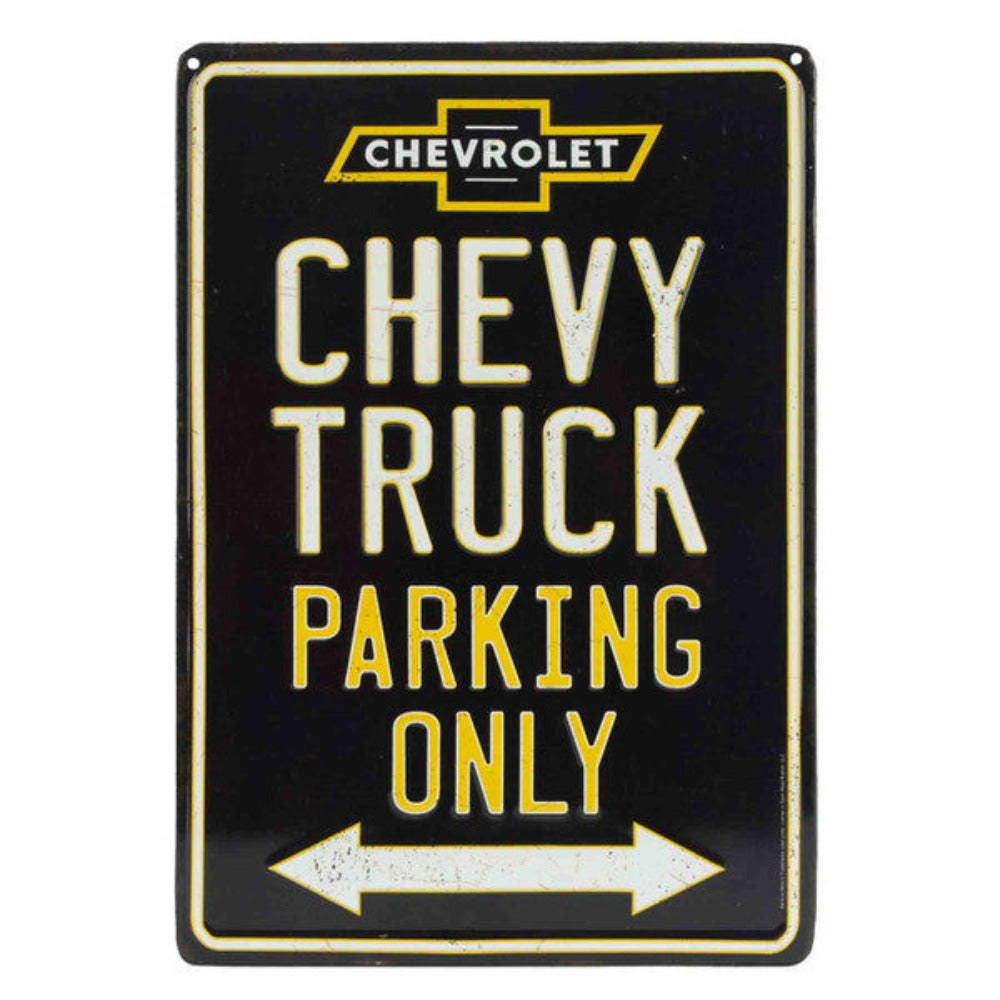 "Chevy Truck Parking Only" embossed on a black tin sign with the Chevrolet logo and a directional arrow, signaling a reserved parking spot for Chevy trucks.