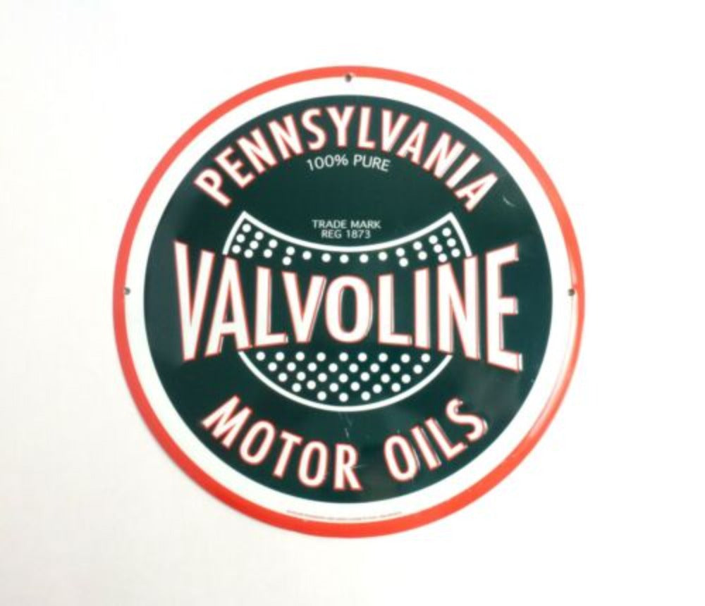 Retro-style "Valvoline Motor Oils" round tin sign featuring traditional Valvoline branding in red and green on a black background.