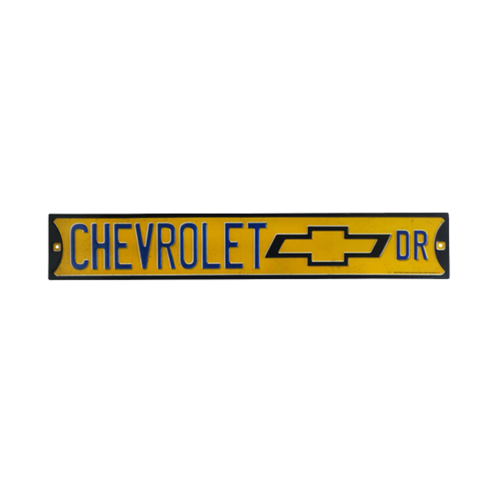 Rectangular embossed tin sign with 'CHEVROLET' lettering and logo in yellow and black, symbolizing brand loyalty and classic car culture.