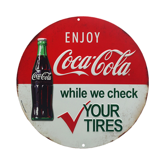 Retro round embossed tin sign featuring Coca-Cola branding and an offer to check tires, symbolizing classic service station nostalgia.