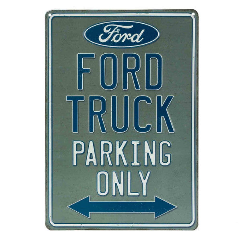 Vintage-style embossed tin sign reading "Ford Truck Parking Only" with a classic Ford logo and an arrow indicating parking direction, with a greyish-blue background.