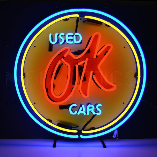 "Chevy Vintage OK Used Cars" neon sign in red, yellow, and blue.