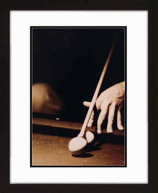 Dramatic 'Corner Shot' billiards framed artwork depicting a close-up of a player's hand preparing for a pool shot, showcasing the tension and focus of the game.